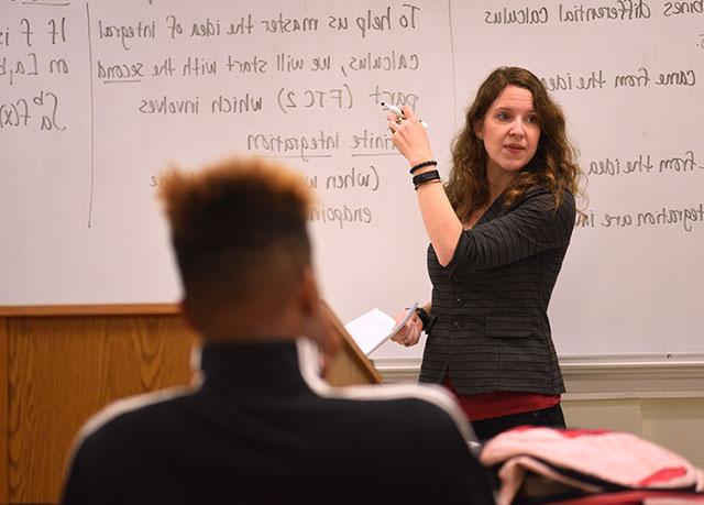 {Female professor at a white board}